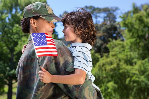 soldier with son holding flag